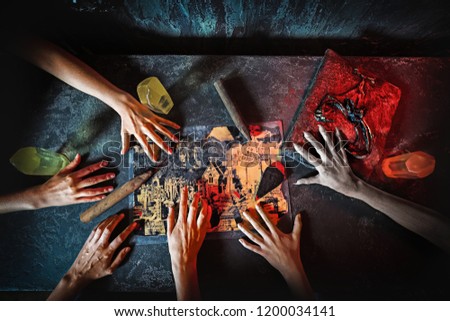 Top view of hands in quest game. Solving a puzzle during riddle. Escape the room game concept Royalty-Free Stock Photo #1200034141