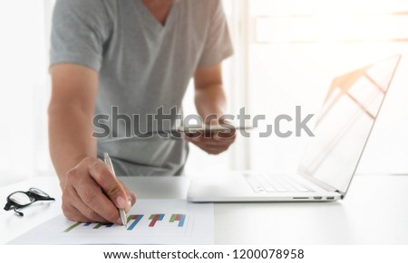 man working at office with laptop and documents on desk