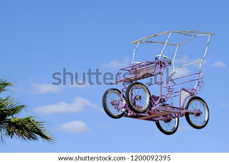 Original quadricycle takes flight to the sky. Royalty-Free Stock Photo #1200092395