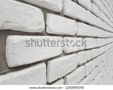 Masonry walls of white silicate brick bonded with cement in the future in perspective. Artistic texture and background. Outdoor street landscaping area of stone. Grid with rectangular cells.