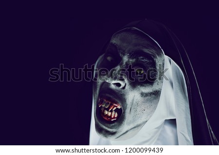 closeup of a frightening evil nun, with bloody teeth and scary eyes, wearing a typical black and white habit, against a black background, with some blank space on the left