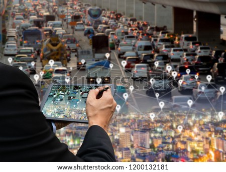 Businessman holds a tablet car on the road network technology of digital map in the city