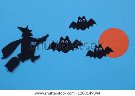 Halloween holiday. Composition with different halloween paper figures on blue background