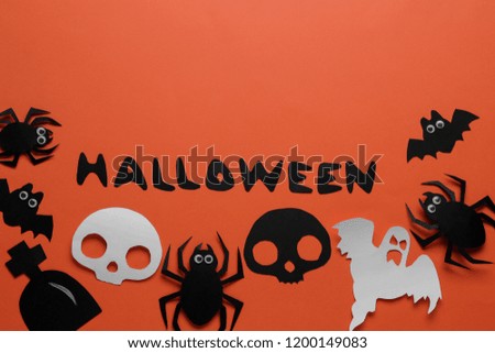 Halloween holiday. Composition with different halloween paper figures. view from above. on orange background