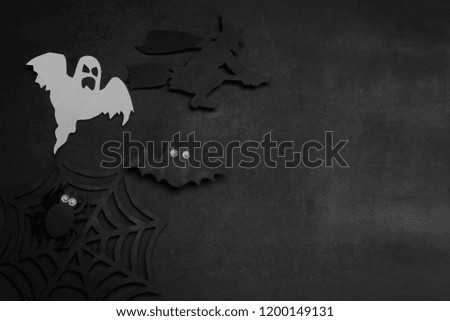 Halloween holiday. Composition with different halloween paper figures. view from above. on a dark background