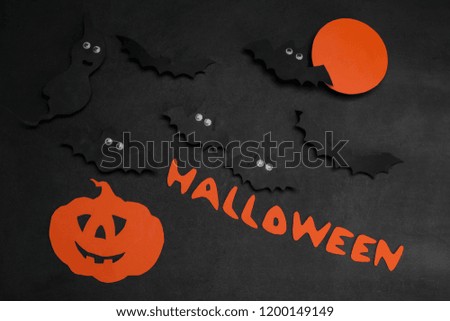 Halloween holiday. Composition with different halloween paper figures. view from above. on a dark background
