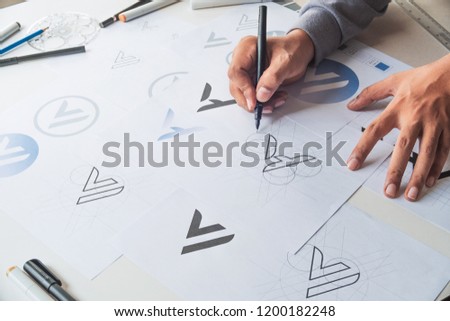 Graphic designer drawing draft Logo 