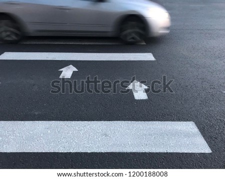 Car crossing a crosswalk with high speed. Human safety.