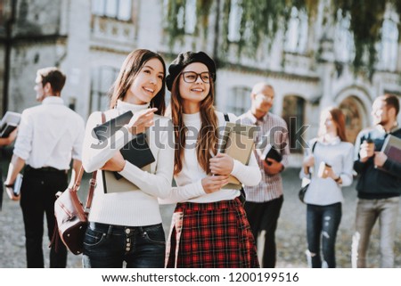 Intelligence. Girls. Happy Together. Students. Courtyard. Books. Standing in University. Good Mood. University. Knowledge. Architecture. Happiness. Diploma. Celebration. Campus. Man. Friends. Happy.