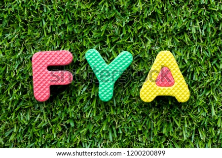 Color alphabet letter in word FYA (Abbreviation of For your action or attention) on artificial green grass background