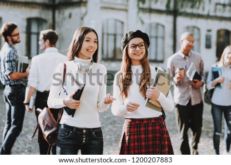 Girls. Happy Together. Students. Courtyard. Books. Standing in University. Good Mood. University. Knowledge. Architecture. Happiness. Intelligence. Diploma. Celebration. Campus. Man. Friends. Happy.