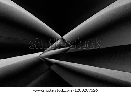 Girders of minimalist building viewed through refraction prism in darkness. Abstract modern architecture in black and white. Contrast chiaroscuro photo with distortion effect.