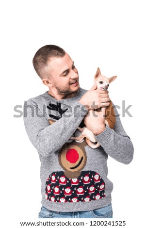 portrait of man in festive winter sweater with little chihuahua dog isolated on white