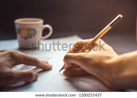 male hand drawing storyboard concept with coffee cup