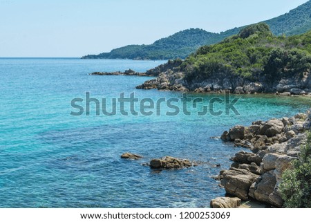Turquoise Seawater surface and beach in Greece