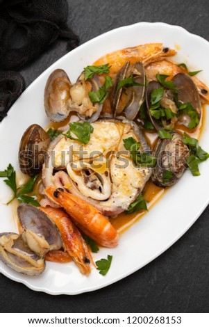 boiled fish with seafood on dish