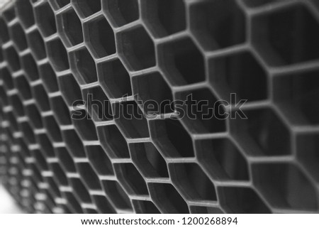 Close-up of the grid of a car that looks like a honeycomb