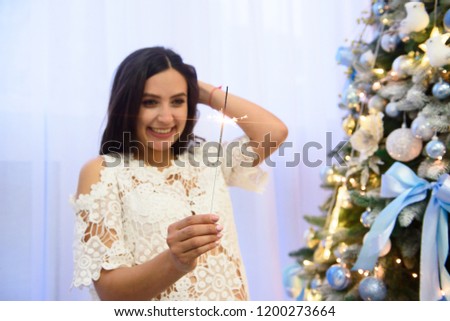 bright festive Christmas sparkler. Sparkler. Female hands holding bengal light. Woman holding bright festive Christmas sparkler in hand
