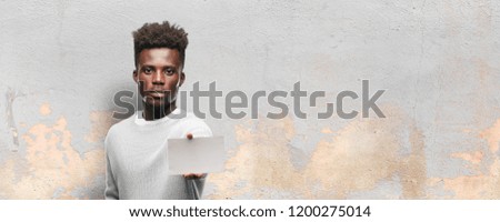 young black man holding an empty placard