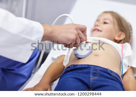 Picture of male doctor testing young girl with usg