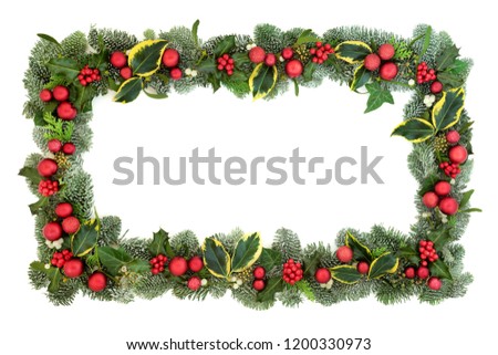 Christmas decorative background border with red bauble decorations, holly, fir, mistletoe and ivy isolated on white background. Festive theme.