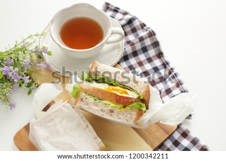 homemade egg and bacon sandwich with tea