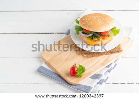 fresh tasty burger on white wooden background.