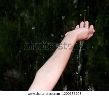 raindrops fall on your hand Royalty-Free Stock Photo #1200353908