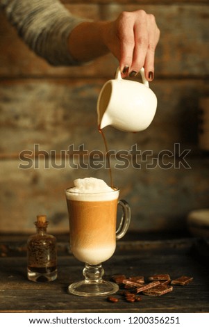 Latte - a cup of coffee with milk in a transparent cup on the table. top view.
