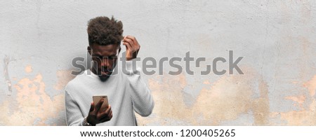 young black man using a smart mobile telephone