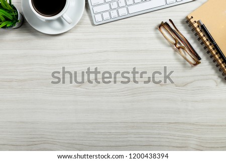 Stylish office table desk. Workspace with laptop, vintage books and coffee mug on white wooden background. Flat lay, top view