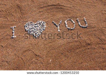 I love You picture from pebble and sand on a beach. Love you background
