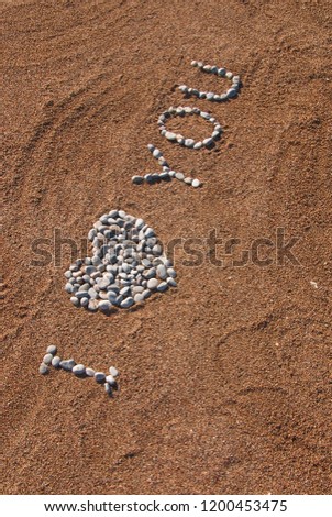 I love You picture from pebble and sand on a beach. Love you background