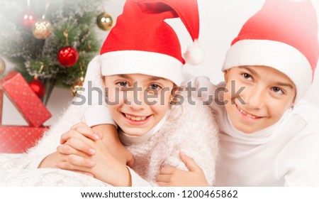 children posing with santa hat in studio
