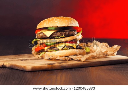 Fast food hamburger and french fries on a wooden Background