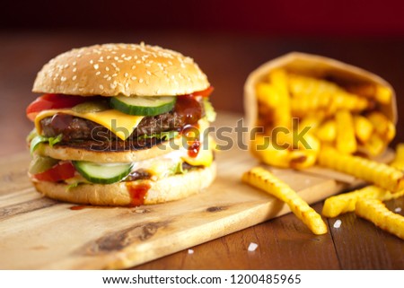Fast food hamburger and french fries on a wooden Background