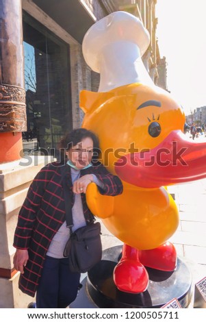 Portrait Photo of Senior asian women with Yellow duck in beijing city the capital of china