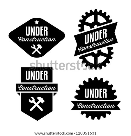 label under construction with gear, hammer, and spanner