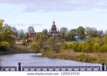 Cityscape scenery. View of the old  provincial townl on an autumn day,  Old wooden churches, river Kamenkaб Suzdal, Russia. Translate: parking, restaurant, bike rental