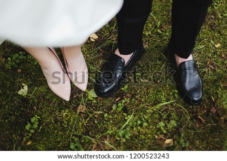 Bridal and groom wedding shoes on the background of green grass. wedding details