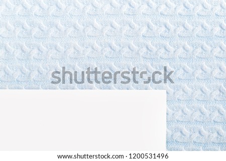 uniform knitted pattern for blue background with paper forms to fill. Handmade.