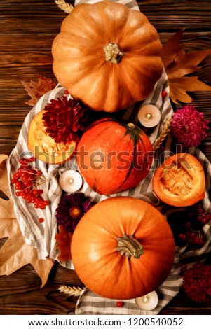 Thanksgiving background concept. Local produce pumpkin, apples & autumn leaves with other fruits, berries & vegetables for decoration on wood textured table. Close up, copy space, top view, flat lay.