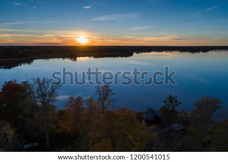 Beautiful sunset in Katrineholm, Sweden, Scandinavia. Lovely nature and landscape on autumn evening. Nice outdoors photo shot with drone in sky from above. Calm, peaceful, stillness and joyful.