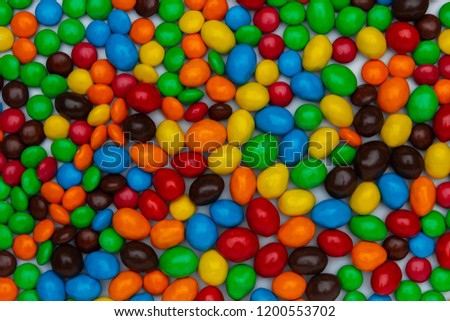 Sweet bonbon colorful candy of different size and color, texture or background. top view, horizontal