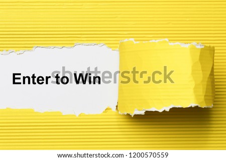 Enter to win text on paper. Word Enter to win on torn paper. Concept Image. Royalty-Free Stock Photo #1200570559