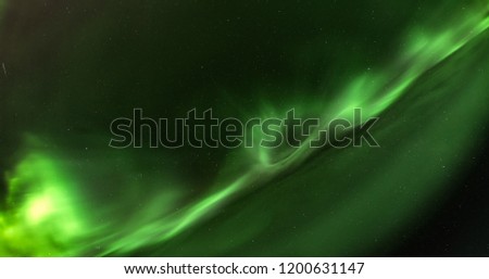 Northern Lights close up high definition photo, very bright green aurora with some magenta nuances, stars shining behind it, north Sweden, no clouds, very good for backgrounds