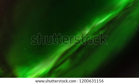 Close up high definition photo of very bright green aurora with stars shining behind it, taken in north Sweden, no clouds, very good for backgrounds