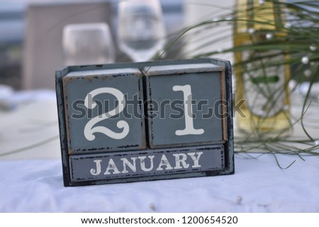 Wood blocks in box with date, day and month 21 January. Wooden blocks calendar