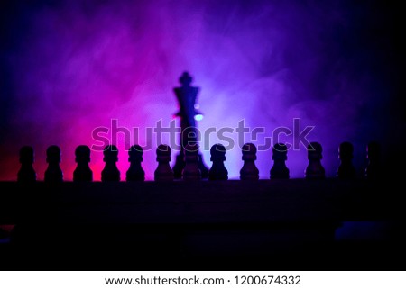 Chess board game concept of business ideas and competition or strategy ideas concept. Chess figures on a dark toned foggy background. Selective focus