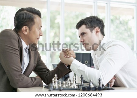 Serious businessman playing board chess game together, Competition and Strategy planning success ideas. Chess board game concept.                                  